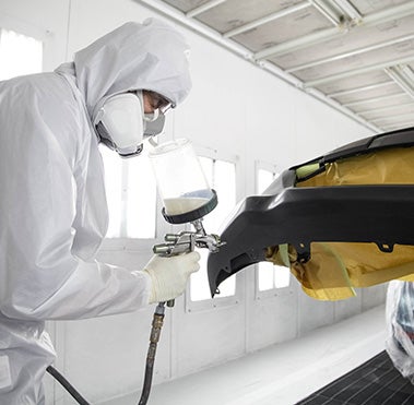 Collision Center Technician Painting a Vehicle | DELLA Toyota of Plattsburgh in Plattsburgh NY
